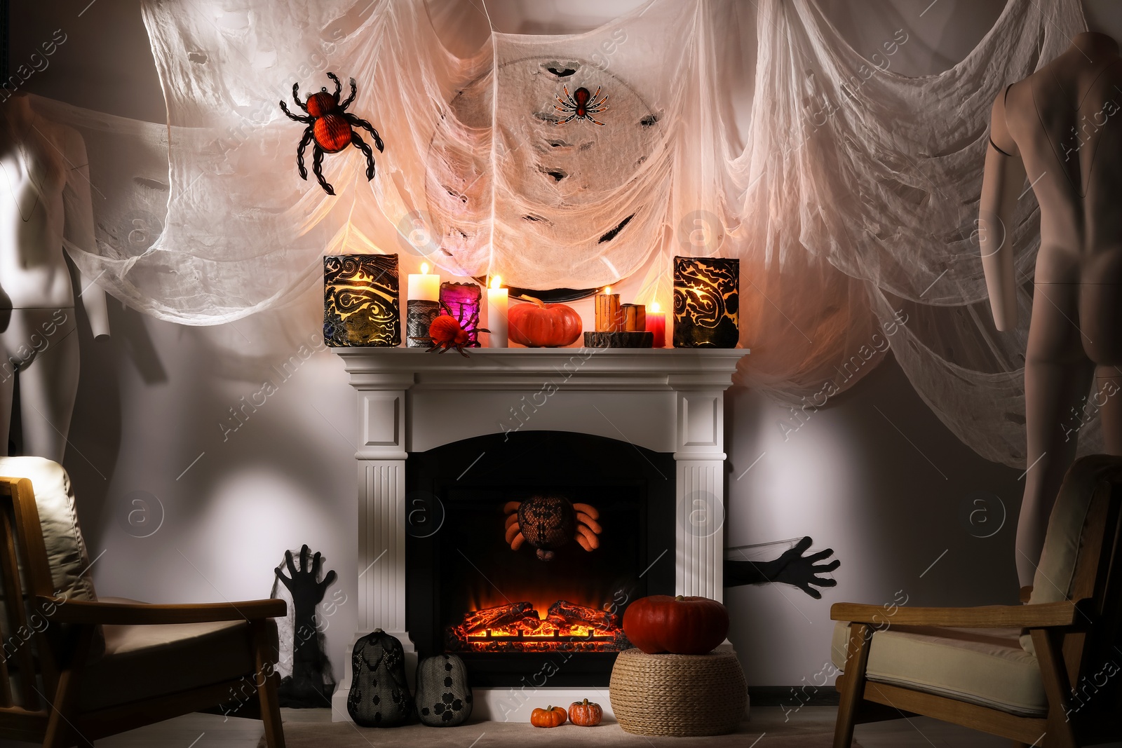 Photo of Room with fireplace decorated for Halloween. Festive interior