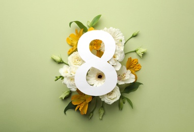 Photo of 8 March greeting card design with beautiful flowers on green background, flat lay. International Women's day