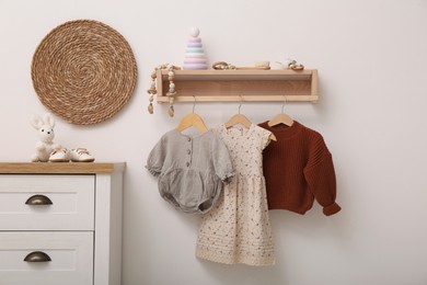 Nursery interior with stylish furniture, clothes and accessories
