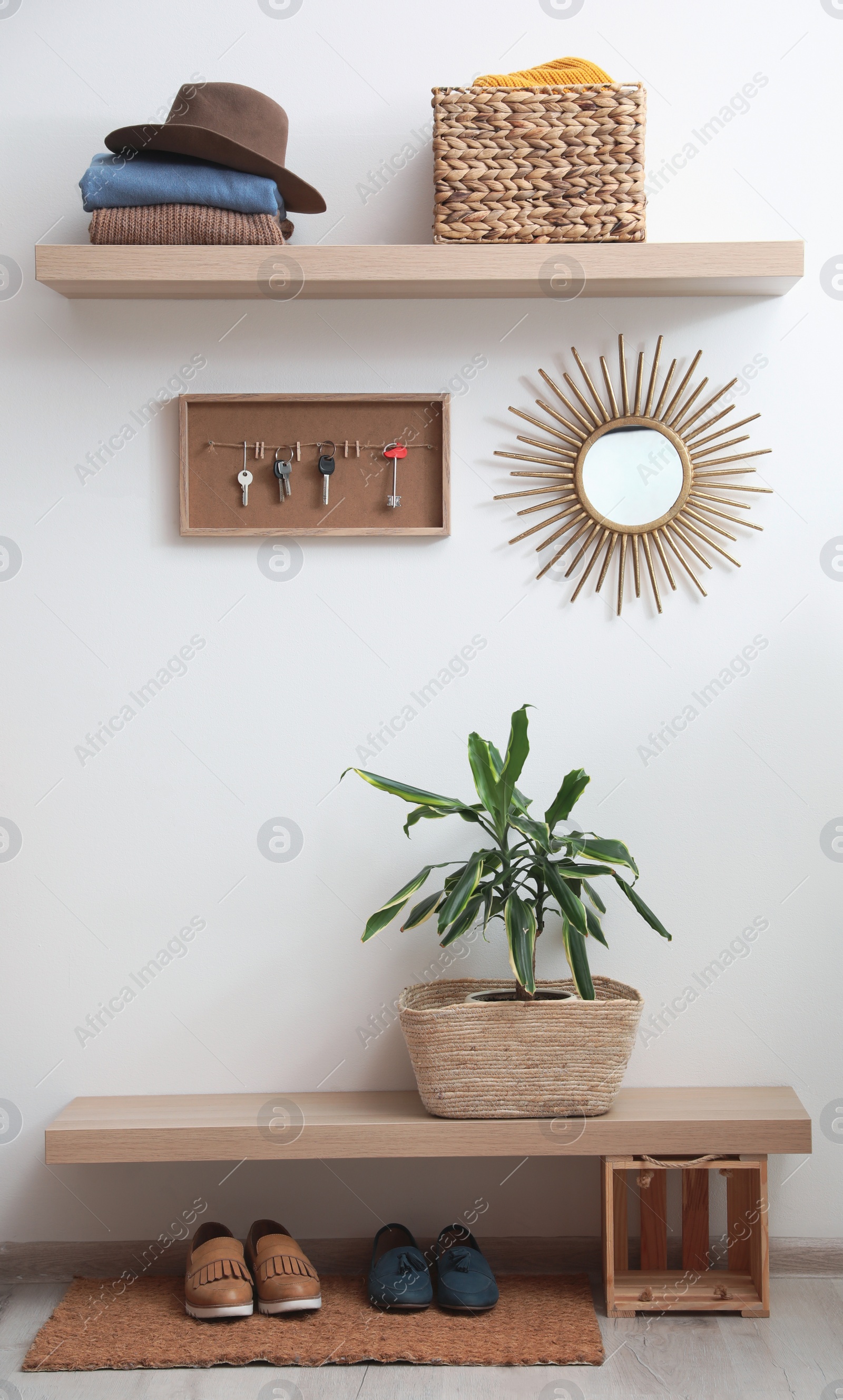 Photo of Hallway interior with stylish furniture, clothes and accessories
