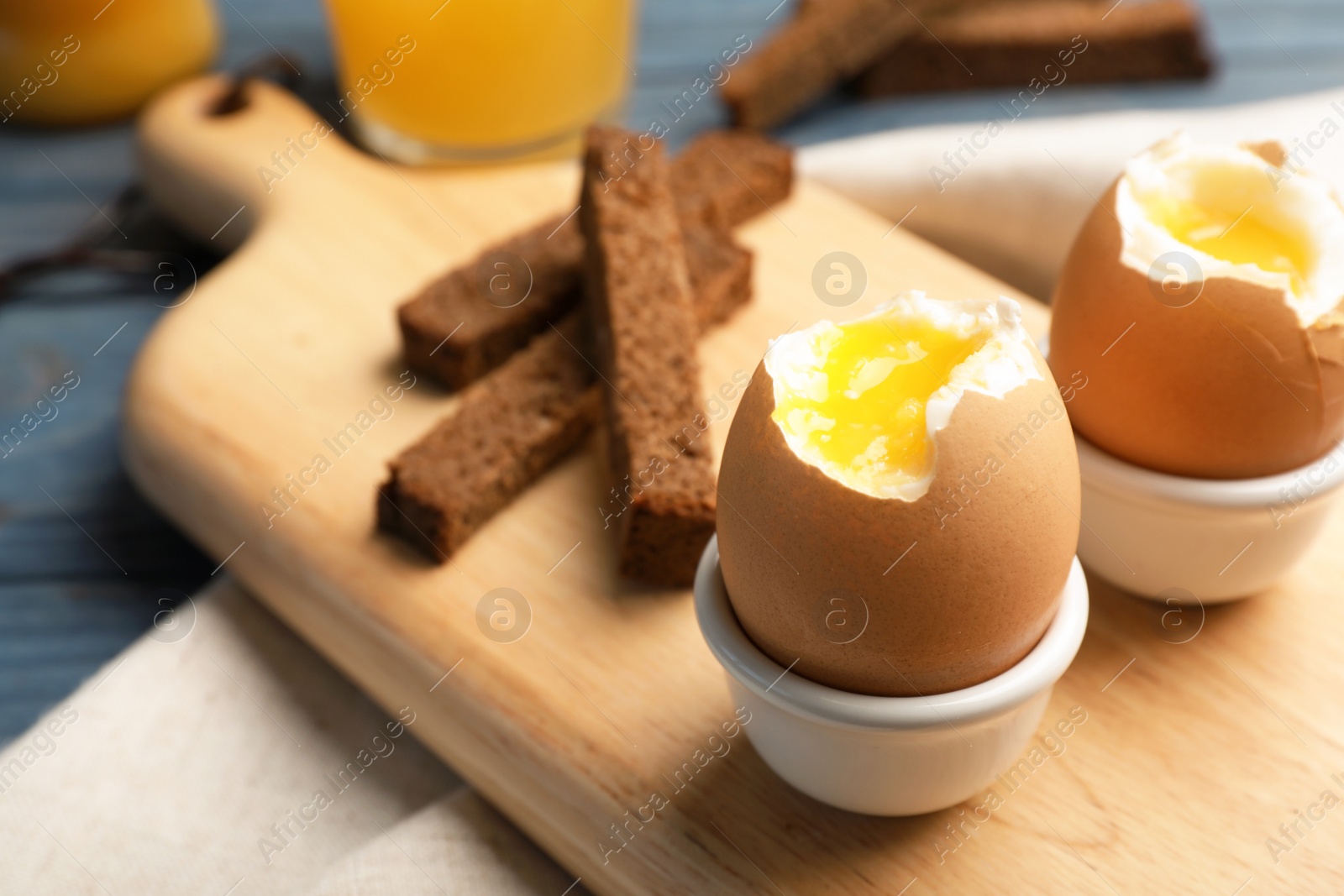 Photo of Holders with soft boiled eggs on table. Space for text