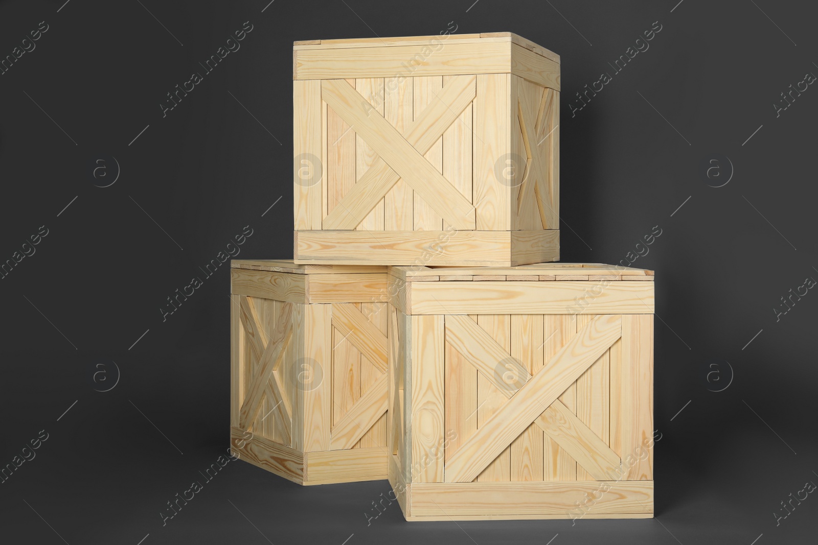 Photo of Wooden crates on dark background. Shipping containers