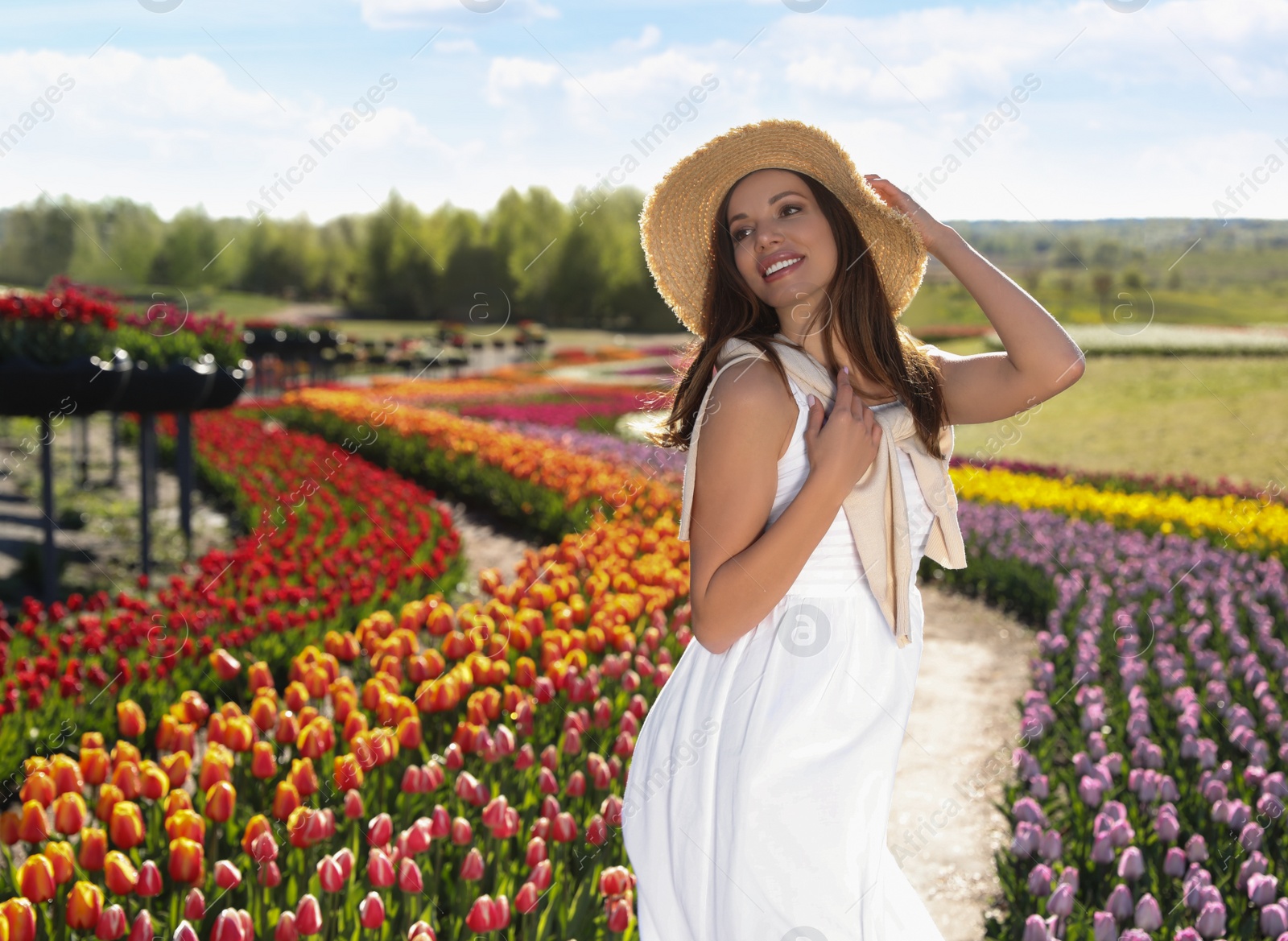 Photo of Woman in beautiful tulip field on sunny day