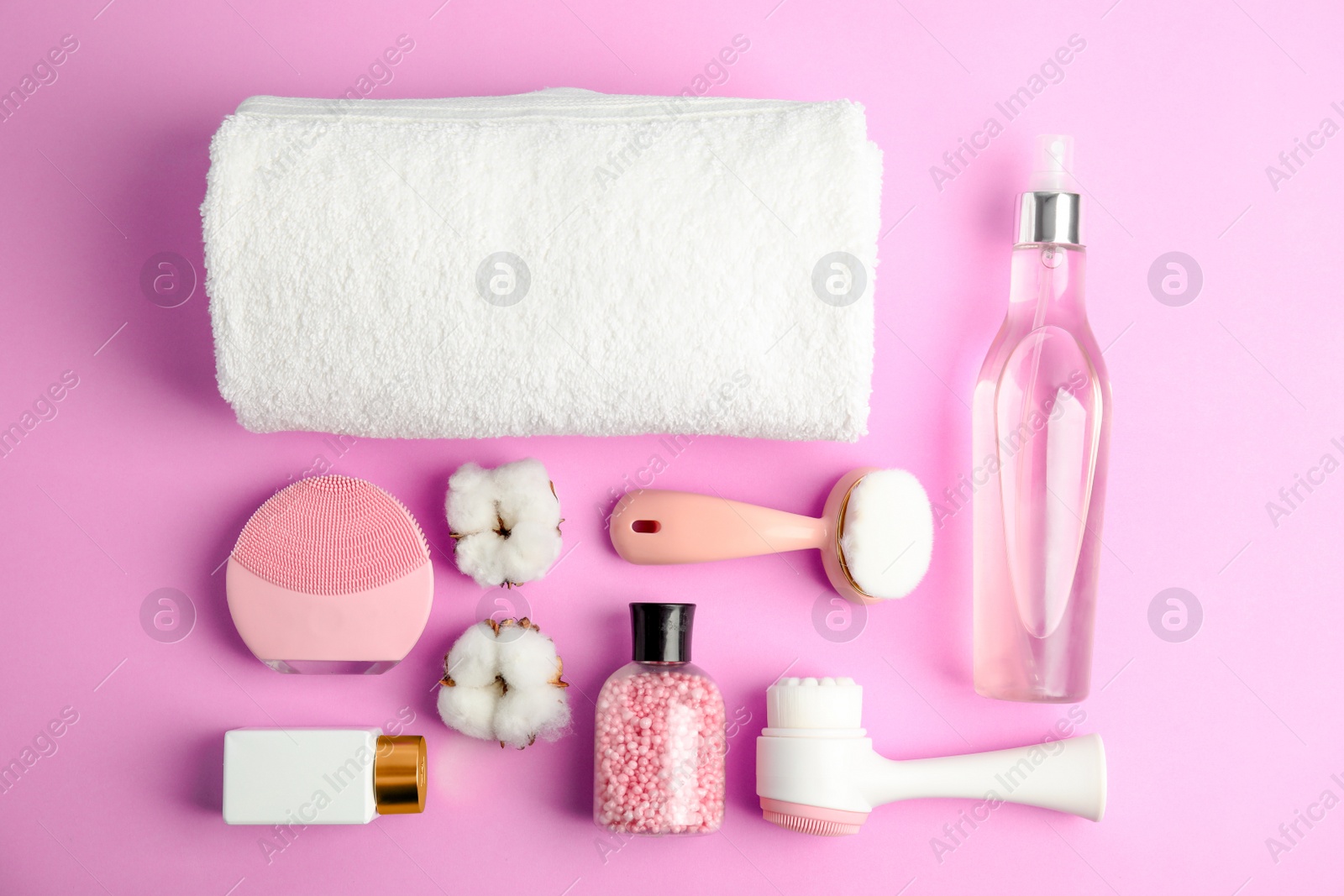 Photo of Flat lay composition with face cleansing brushes on violet background. Cosmetic tools