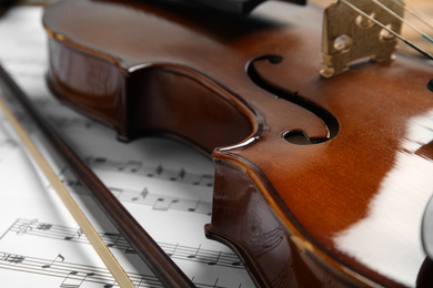 Beautiful violin, bow and note sheets, closeup