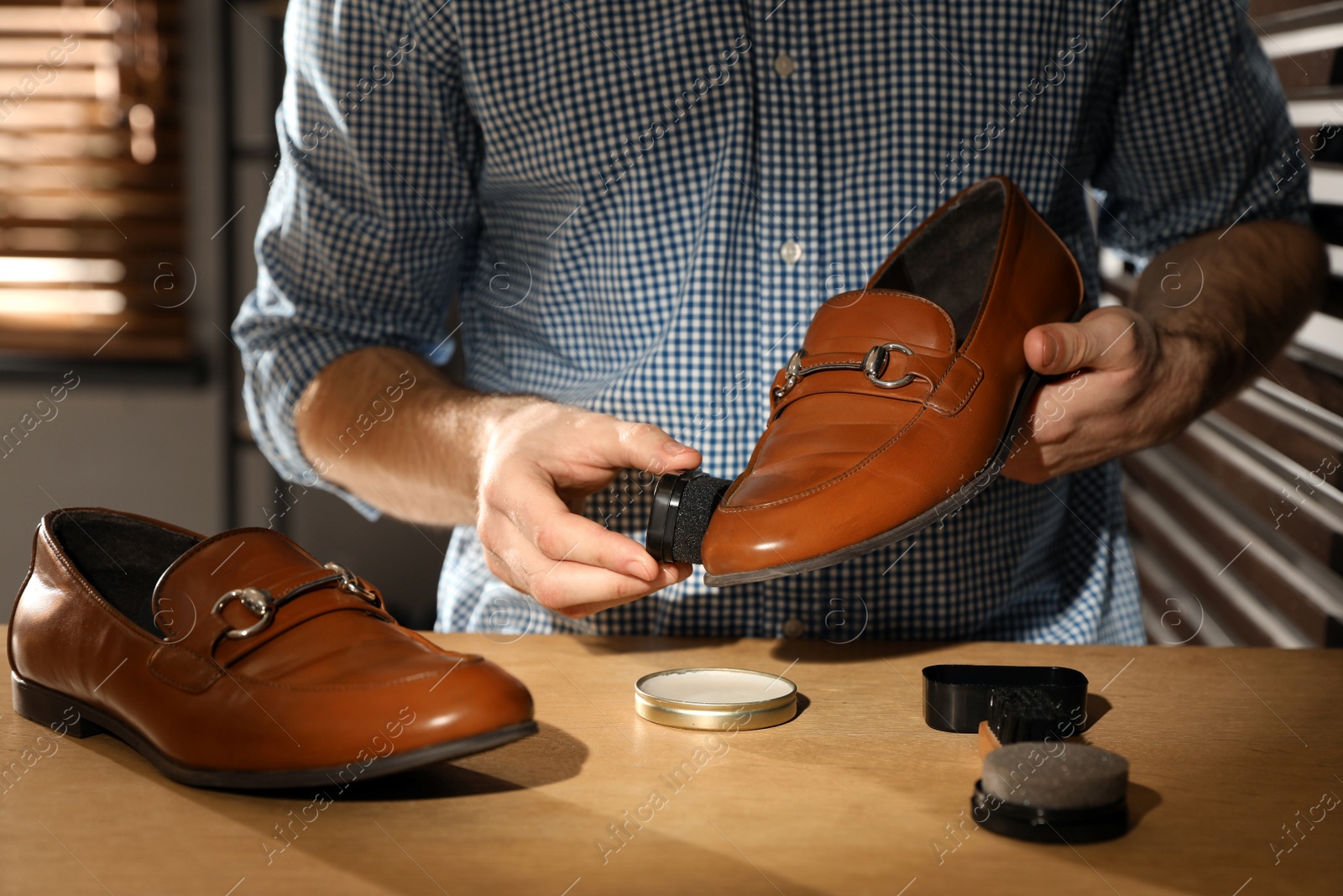 Photo of Master taking care of shoes in his workshop, closeup