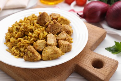 Photo of Plate of delicious rice with chicken on white table, closeup