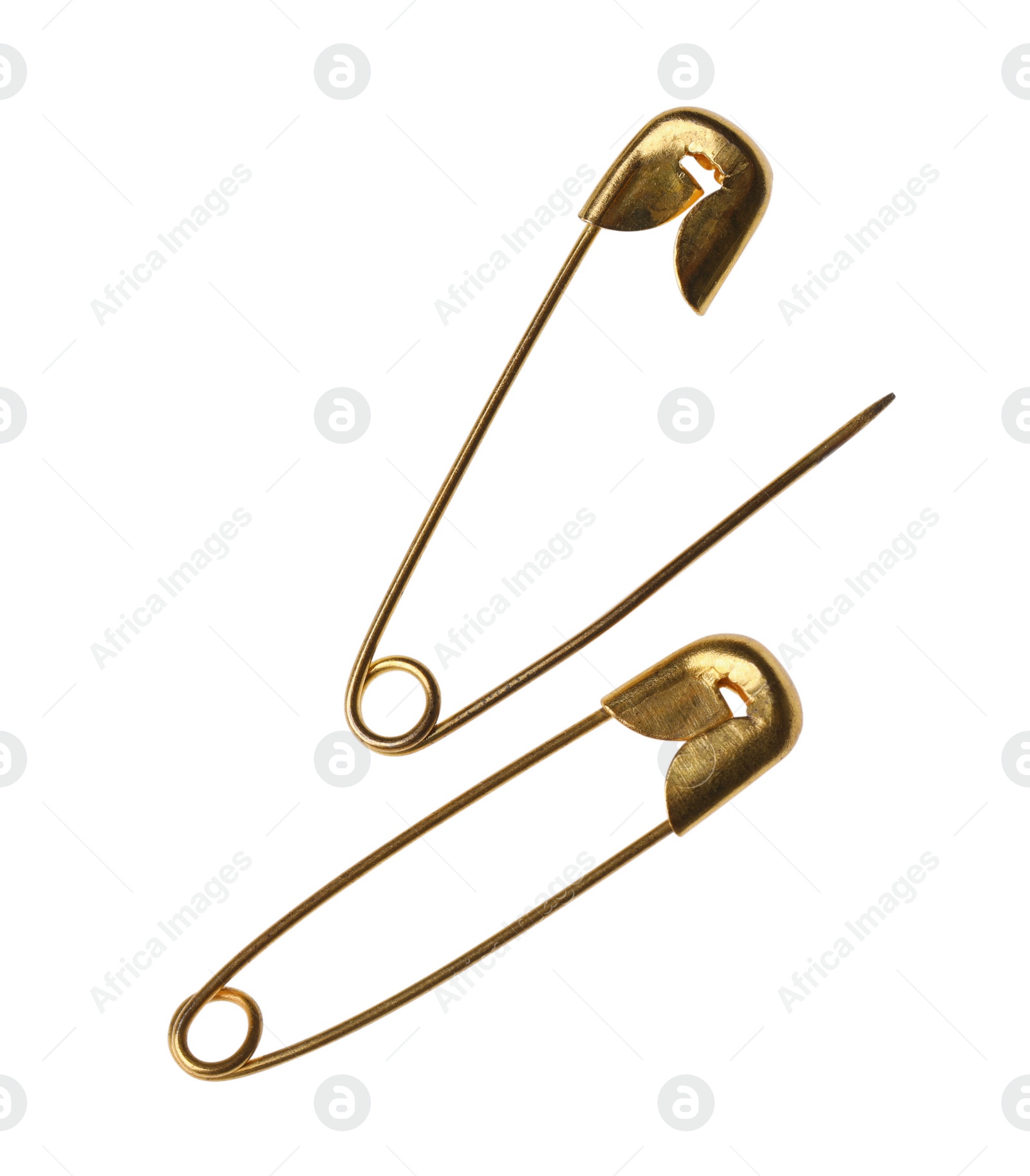 Photo of New golden safety pins on white background