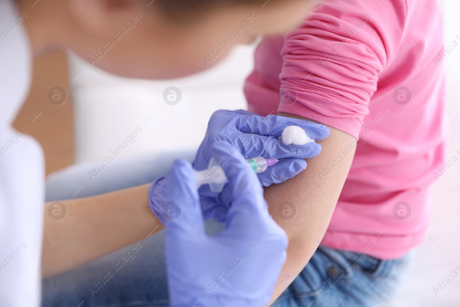 Photo of Little girl receiving chickenpox vaccination in clinic, closeup. Varicella virus prevention