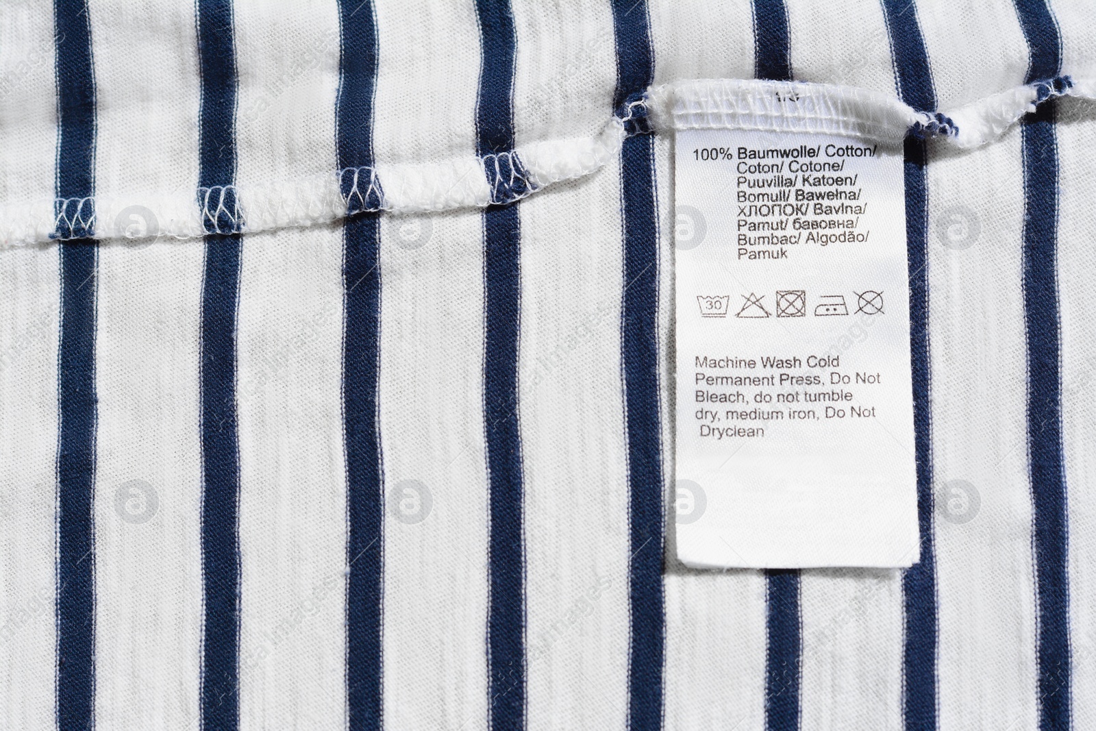 Photo of Clothing label on striped garment, top view