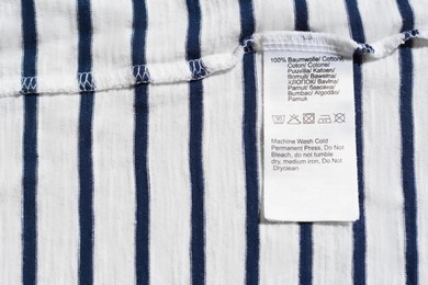 Photo of Clothing label on striped garment, top view