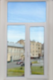 Photo of Blurred view of window with white frame indoors