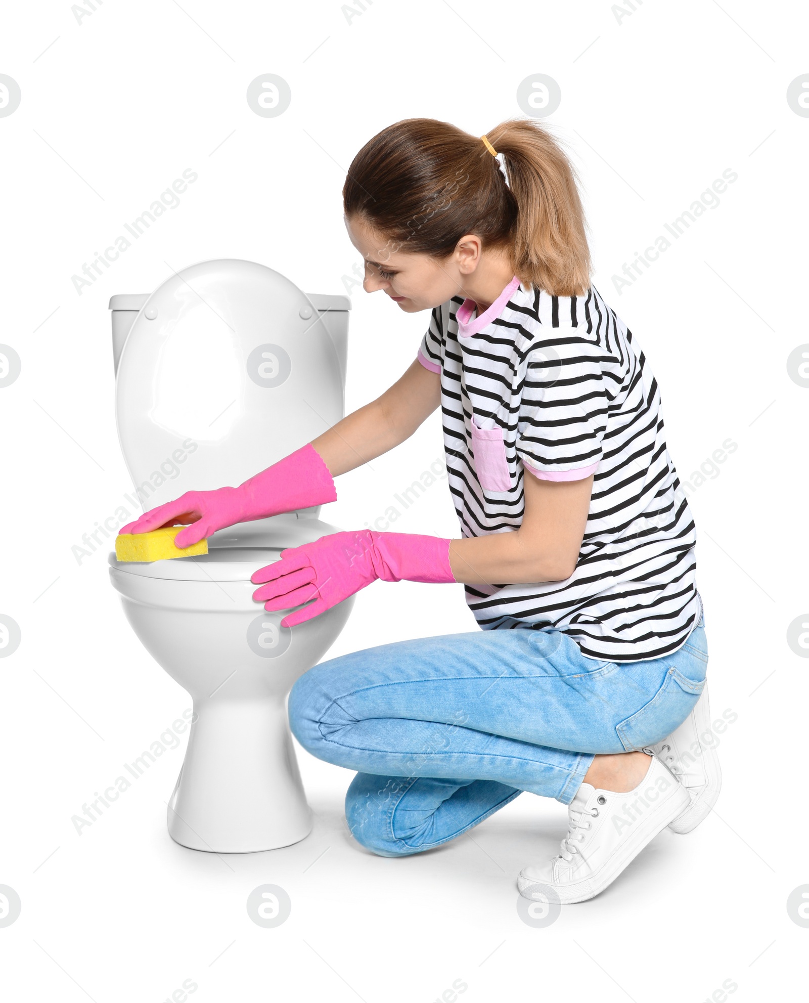 Photo of Woman cleaning toilet bowl in bathroom