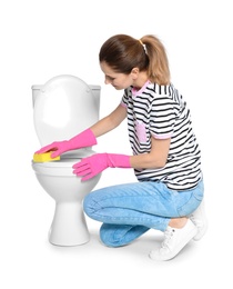 Woman cleaning toilet bowl in bathroom