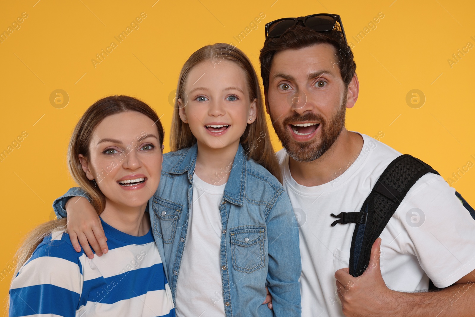 Photo of Portrait of happy family on orange background