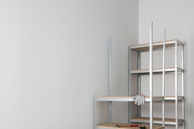 Office room with white walls and metal storage shelves. Space for text