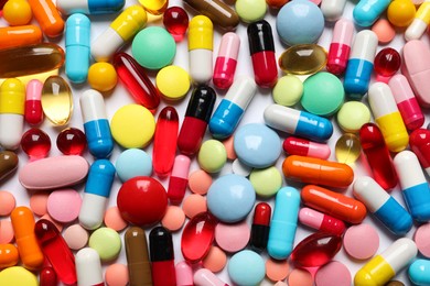 Lots of different colorful pills as background, top view