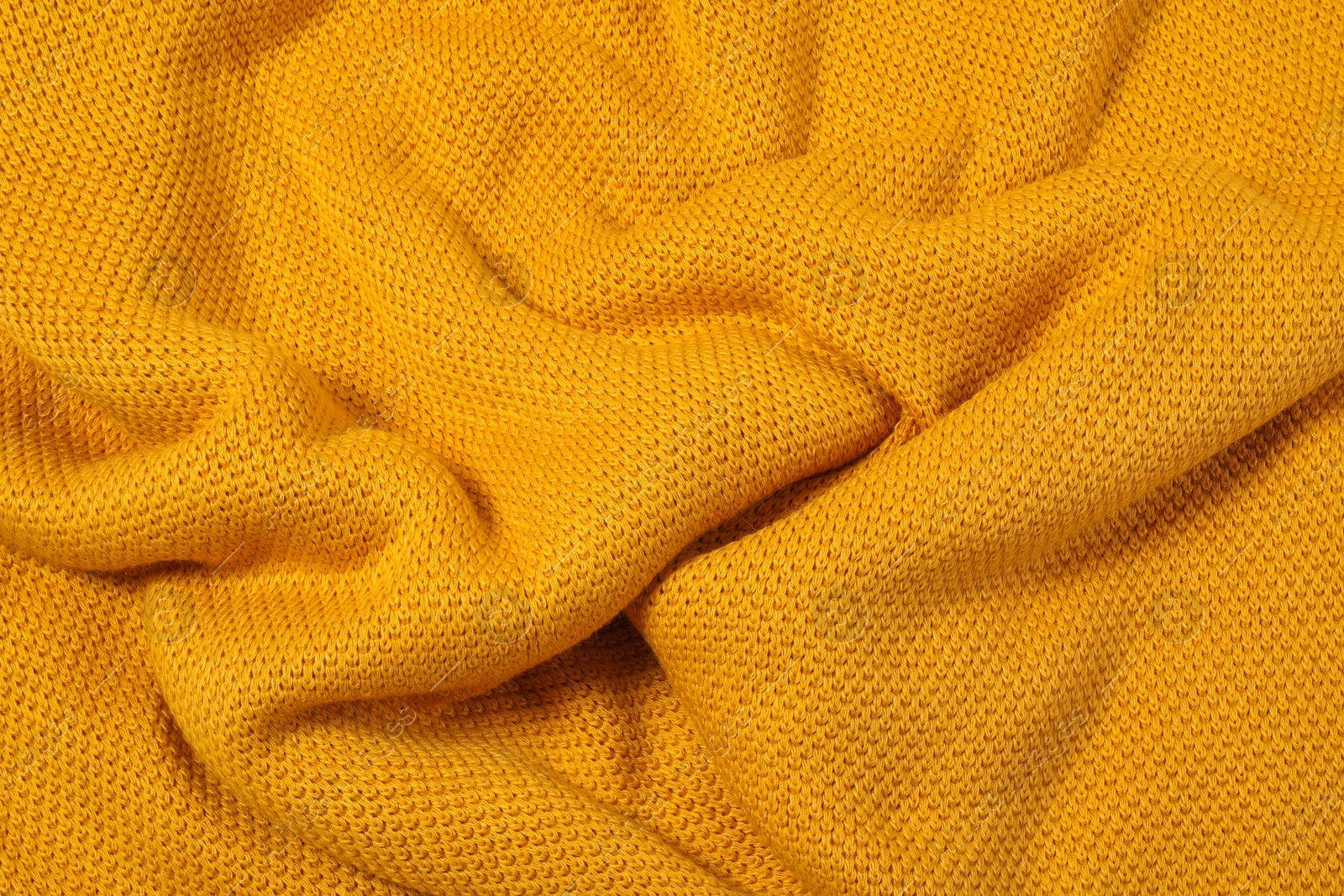 Photo of Texture of yellow knitted blanket as background