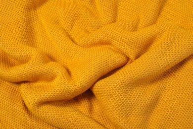 Texture of yellow knitted blanket as background