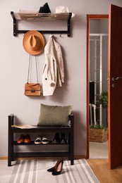 Photo of Hallway interior with stylish furniture, clothes and accessories