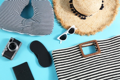 Photo of Flat lay composition with travel pillow and tourist stuff on light blue background