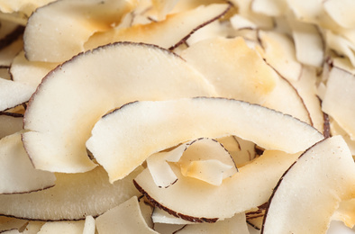 Photo of Delicious fresh coconut chips as background, closeup