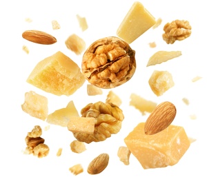 Pieces of delicious parmesan and walnuts on white background