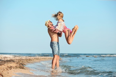 Photo of Young couple spending time together on beach