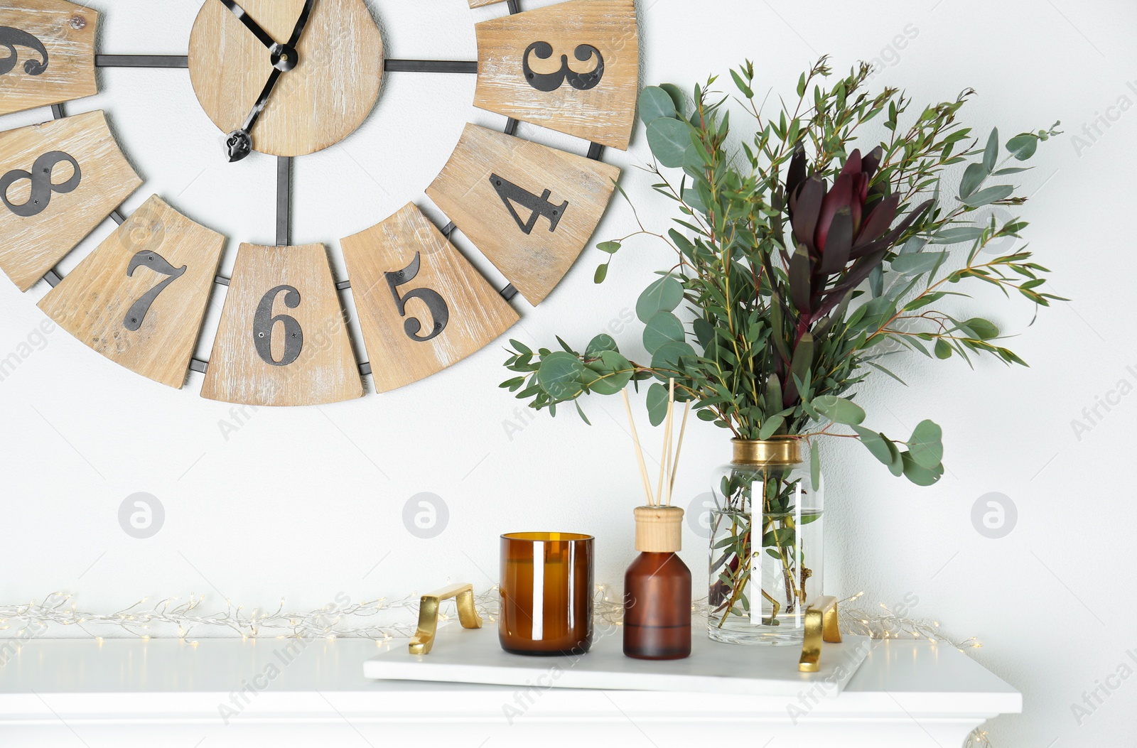 Photo of Reed air freshener with candle and bouquet on  marble tray