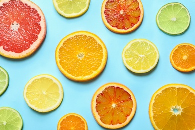 Different citrus fruits on color background, flat lay