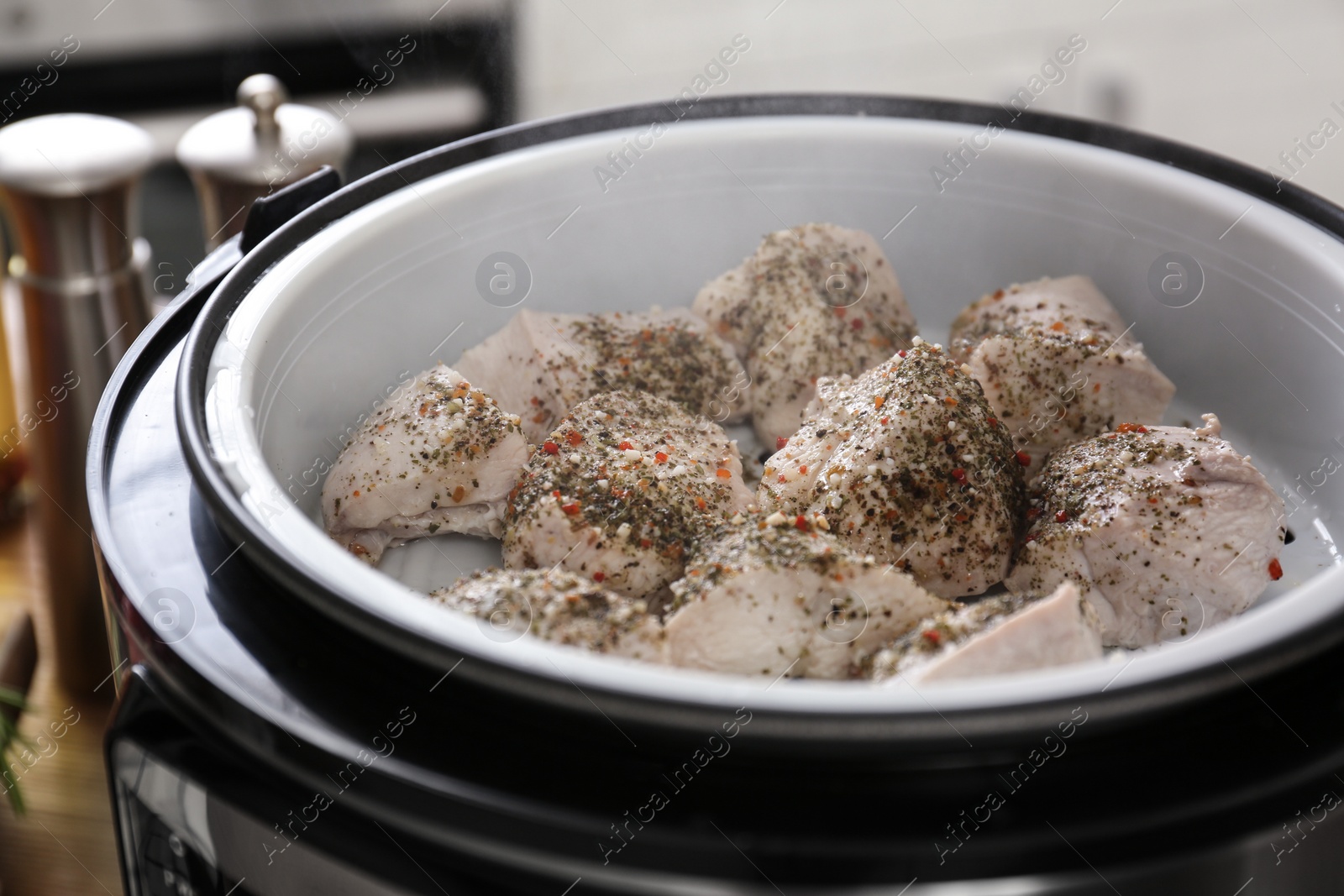 Photo of Delicious chicken with spices in modern multi cooker, closeup