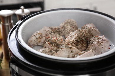 Photo of Delicious chicken with spices in modern multi cooker, closeup