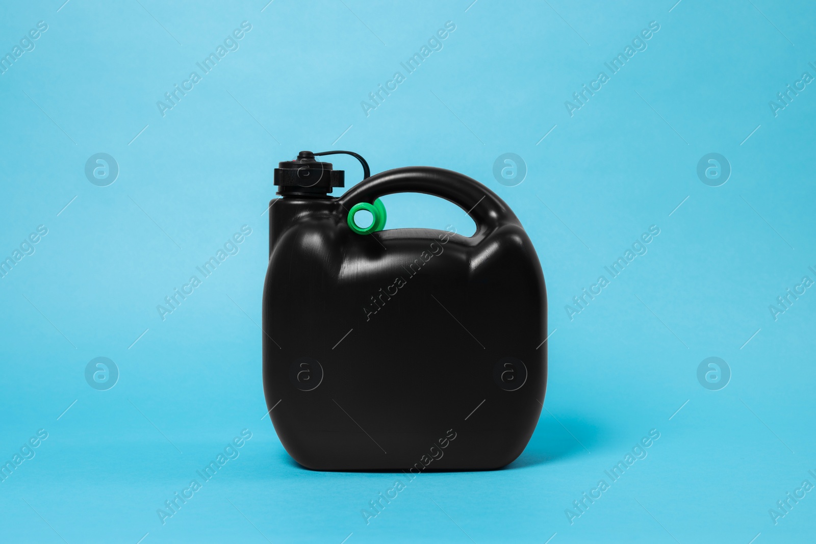 Photo of New black plastic canister on light blue background