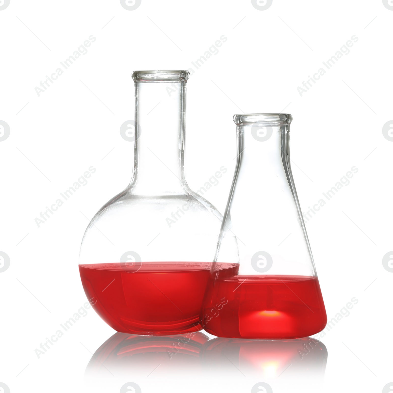 Photo of Florence and conical flasks with liquid samples isolated on white. Chemistry glassware