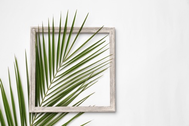 Photo of Beautiful composition with tropical leaf on light background, top view