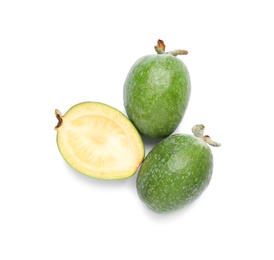 Cut and whole feijoas on white background, top view