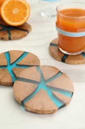 Photo of Stylish wooden cup coasters on white table