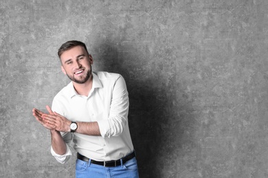 Photo of Portrait of handsome laughing man on grey background