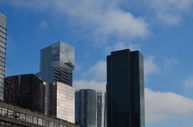 Exterior of different modern skyscrapers against blue sky