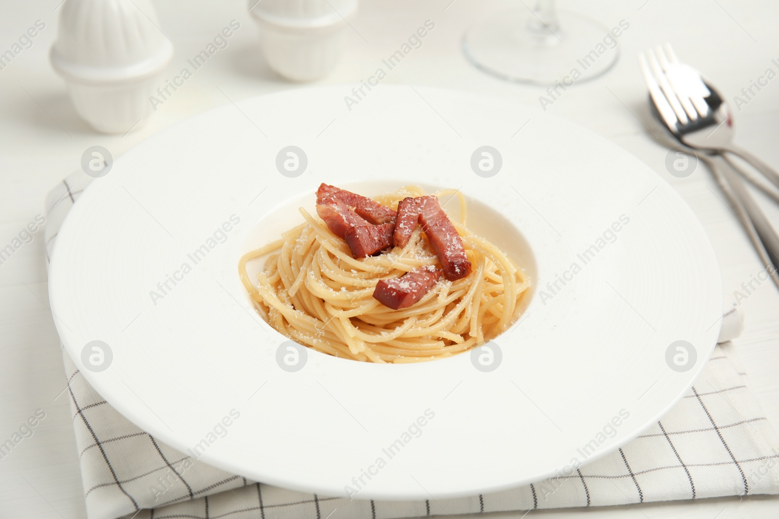 Photo of Delicious Carbonara pasta served on white table