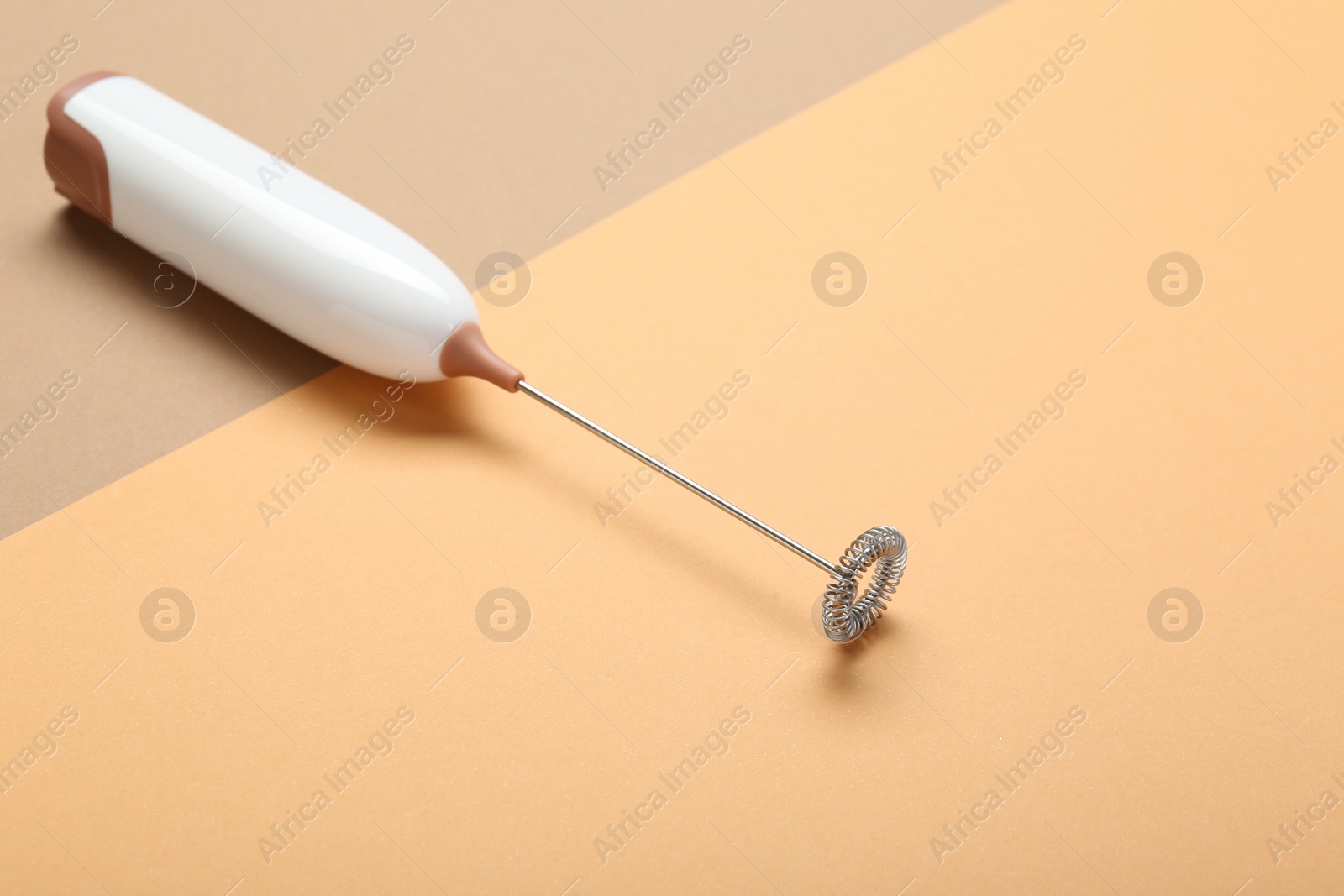 Photo of White milk frother wand on color background, space for text