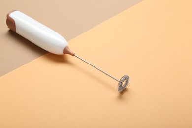 White milk frother wand on color background, space for text