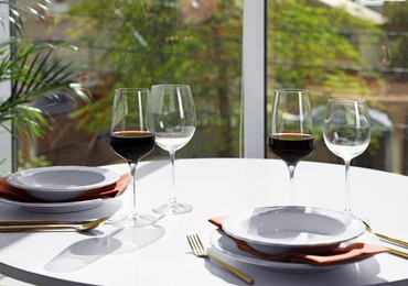 Photo of Glasses of wine on table in restaurant