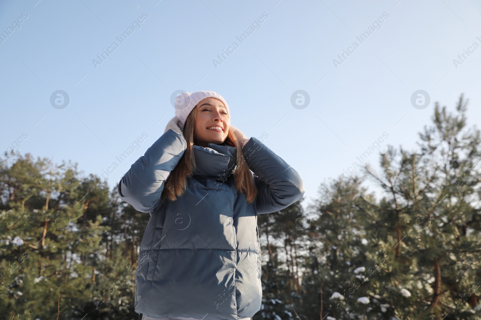 Photo of Woman enjoying winter day in forest, space for text