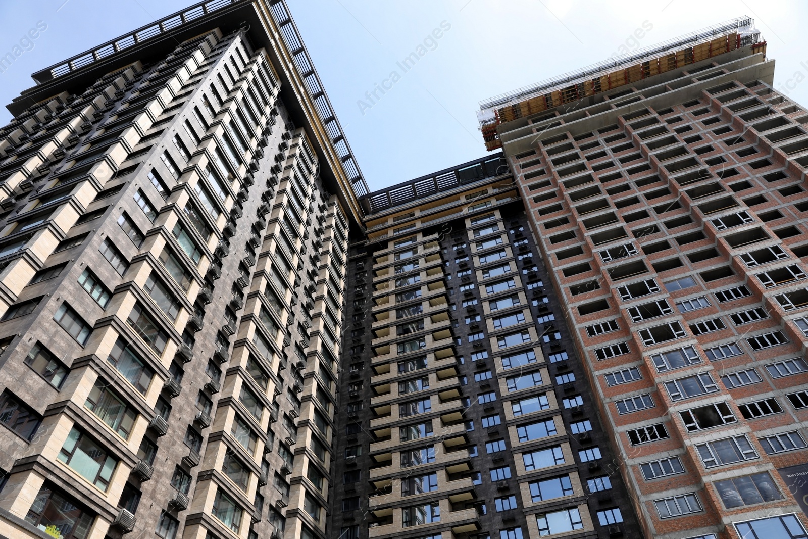 Photo of Unfinished modern building against blue sky, low angle view