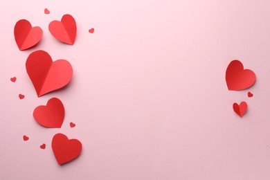 Paper hearts on pink background, flat lay. Space for text