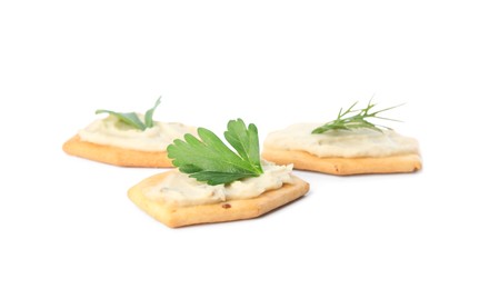 Photo of Delicious crackers with humus, parsley and dill on white background