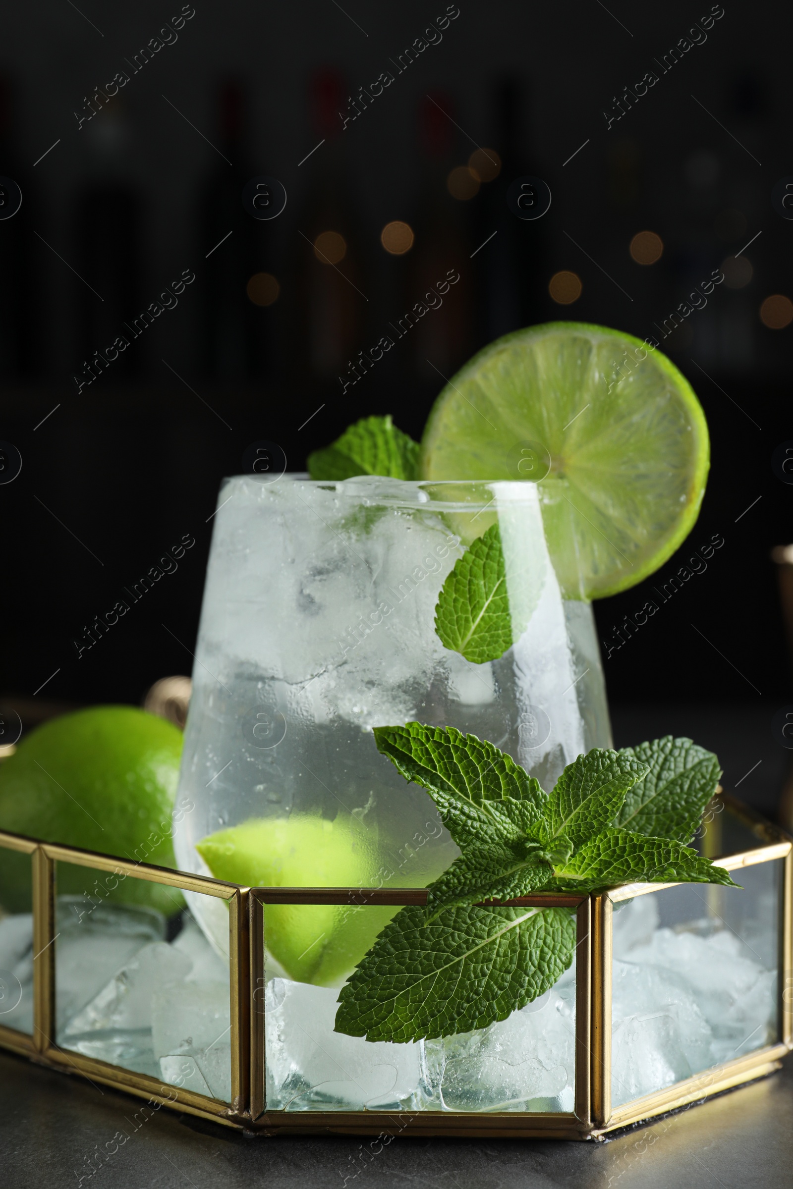 Photo of Cocktail with vodka and lime on dark table