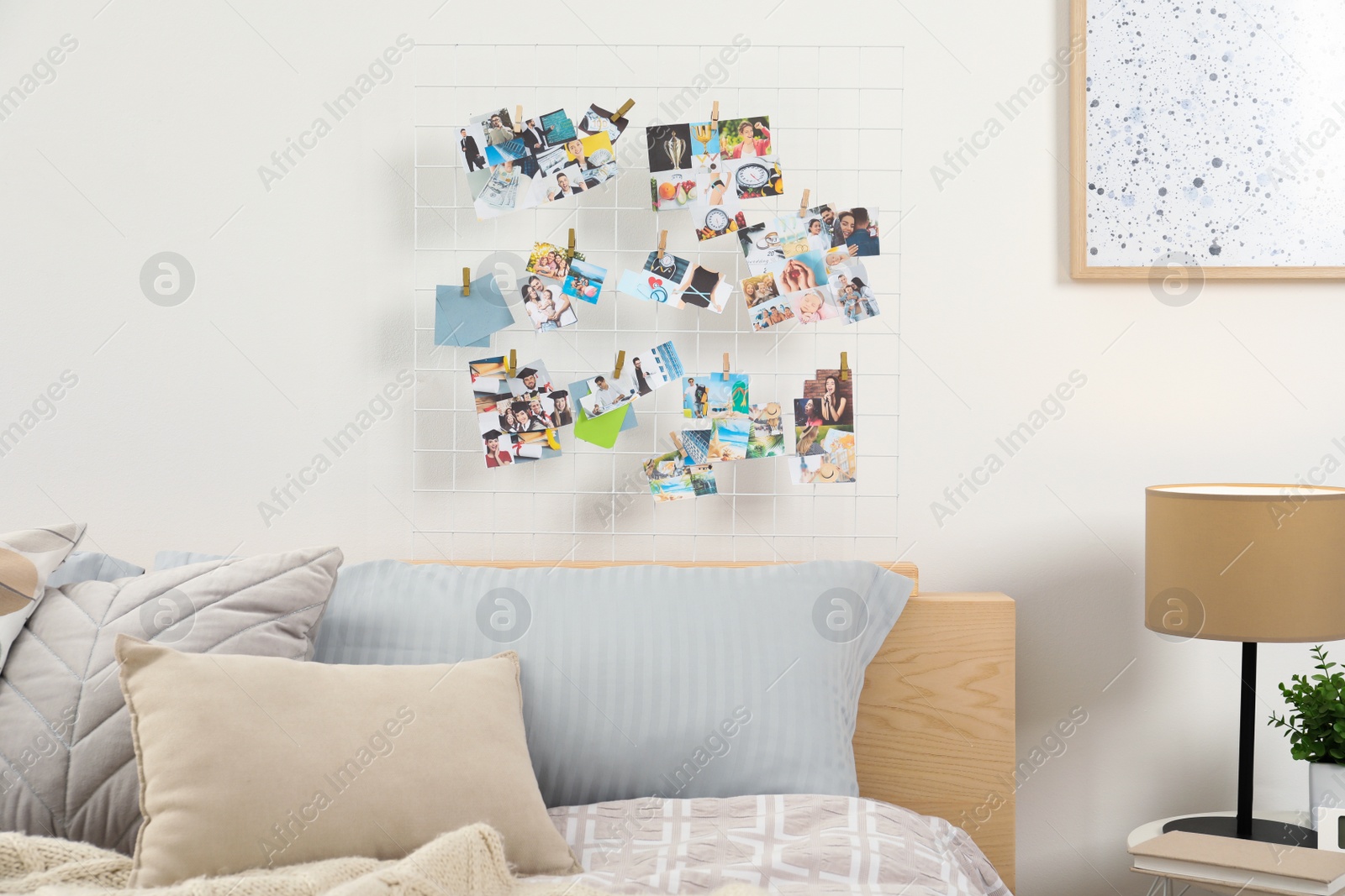 Photo of Stylish room interior with comfortable bed and vision board on wall