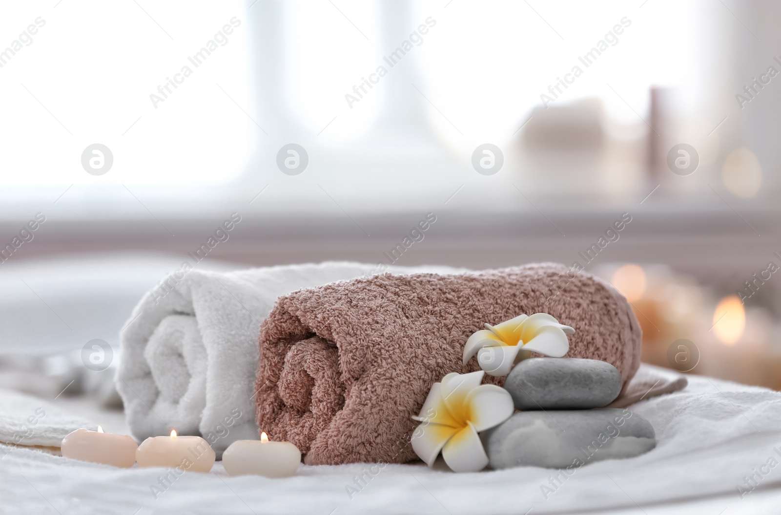 Photo of Beautiful spa composition on massage table in wellness center